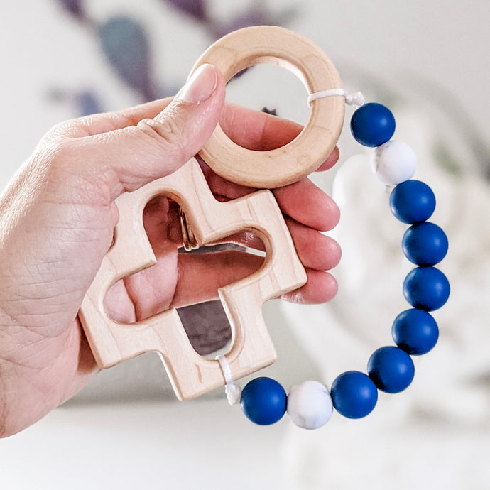 Blue and Marble teething rosary held in hand