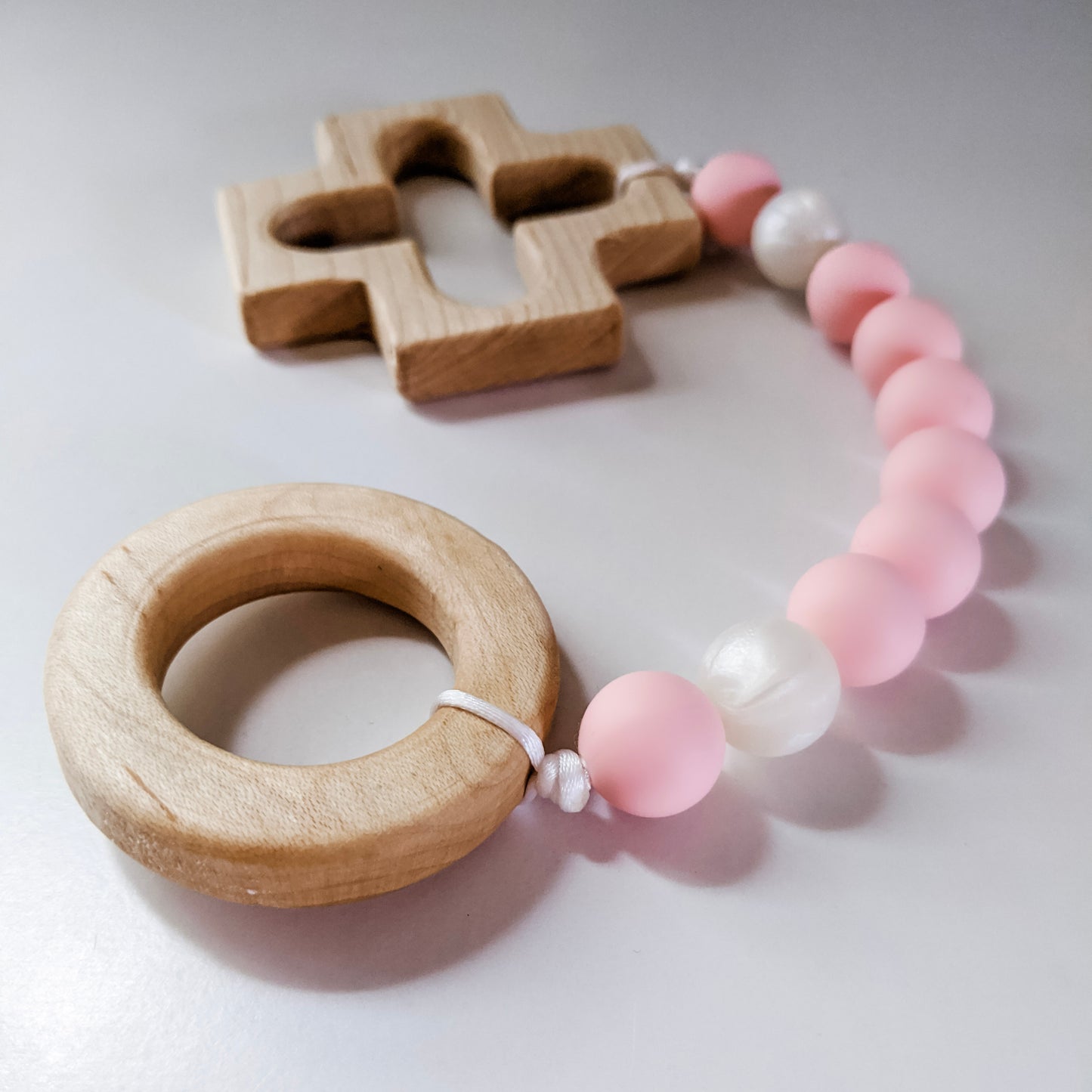 Silicone baby rosary with wooden cross and ring at either end