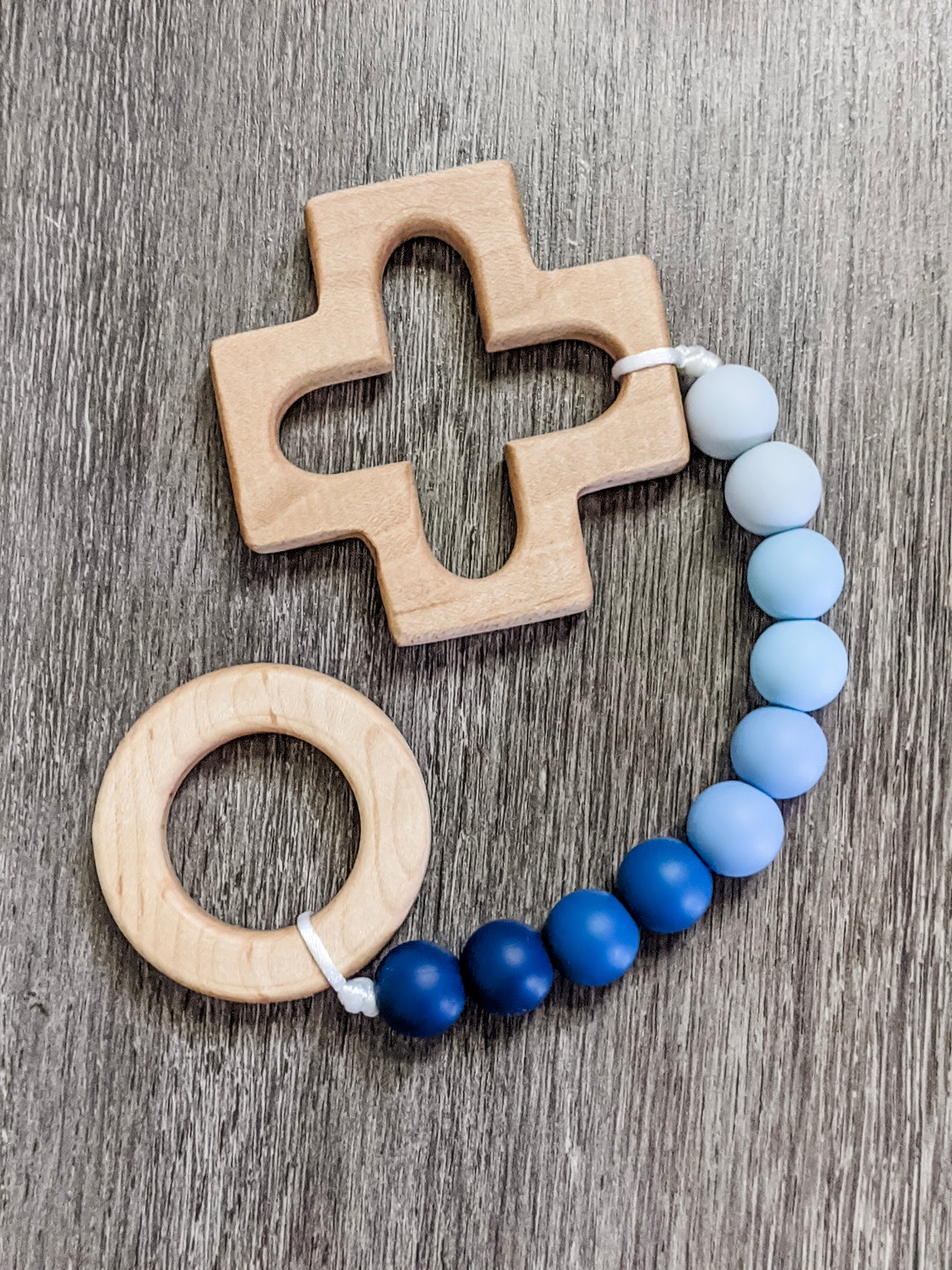 Rosary teething strand in blue ombre with wooden cross and ring teethers