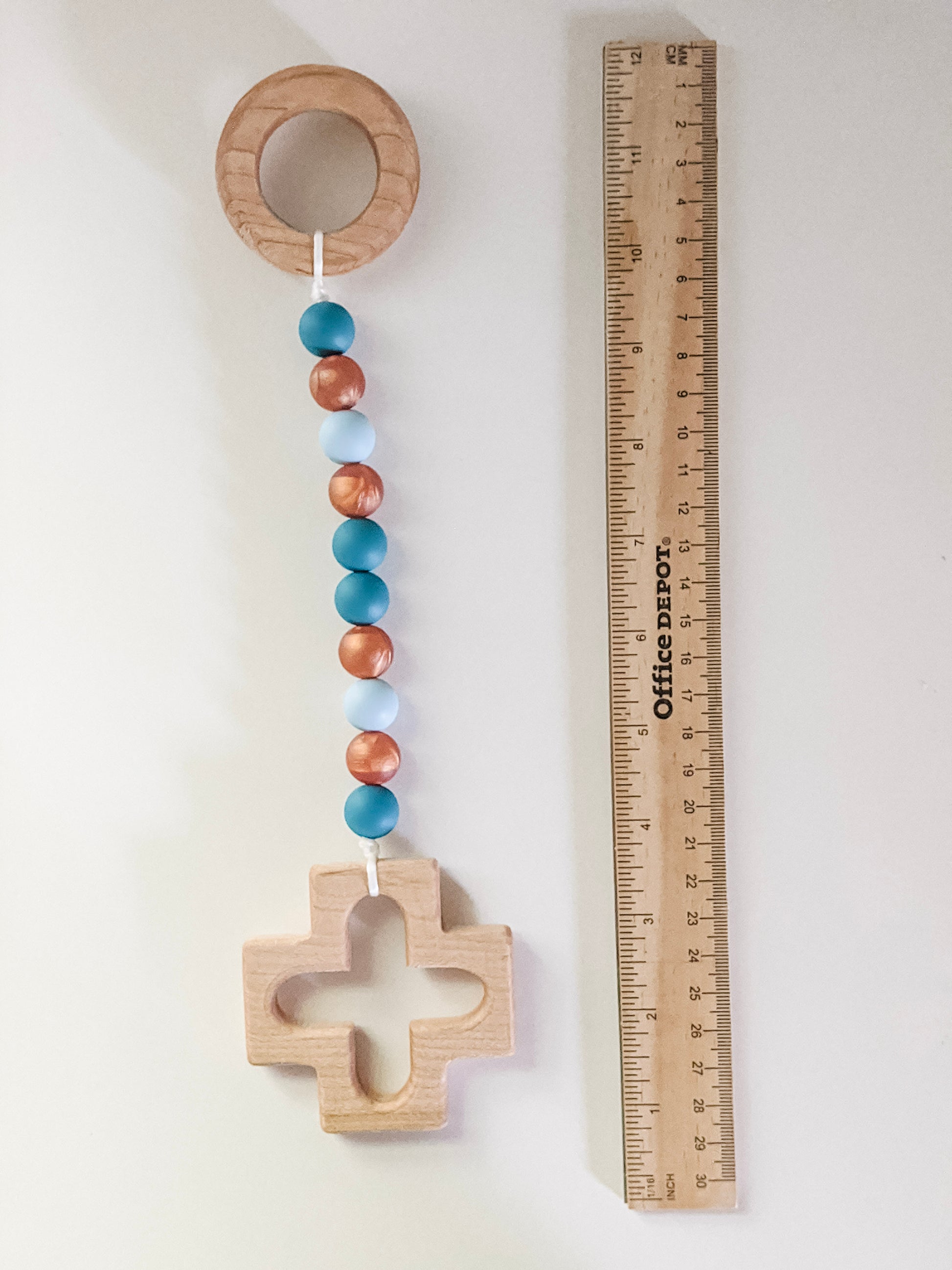 Our Lady of Guadalupe Baptism gift teether next to ruler