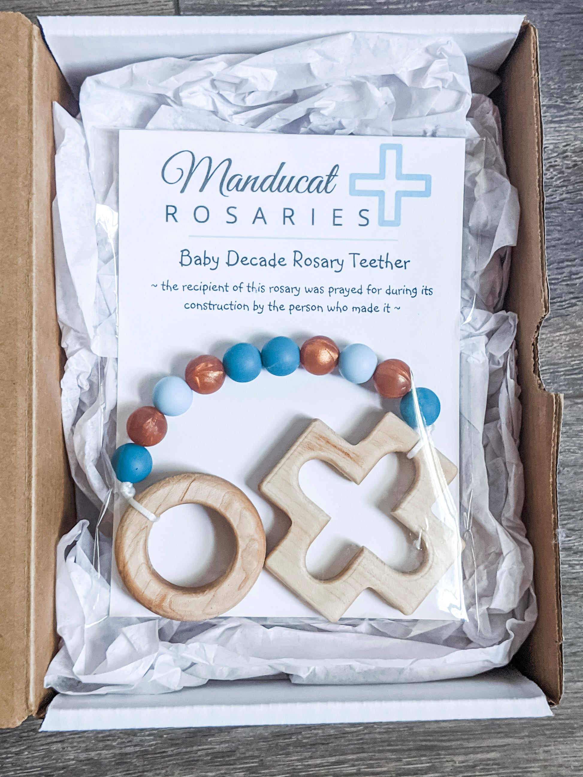 Catholic Baptism gift in packaging that states the baby was prayed for during the item's construction