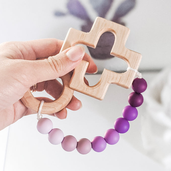 Catholic teething rosary strand in purple ombre with wooden cross and ring teethers