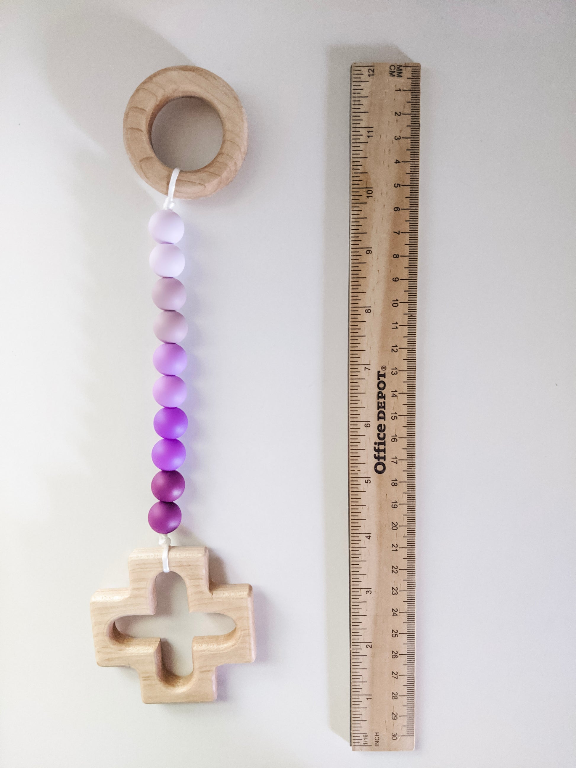 Purple ombre decade rosary teething strand next to ruler showing size