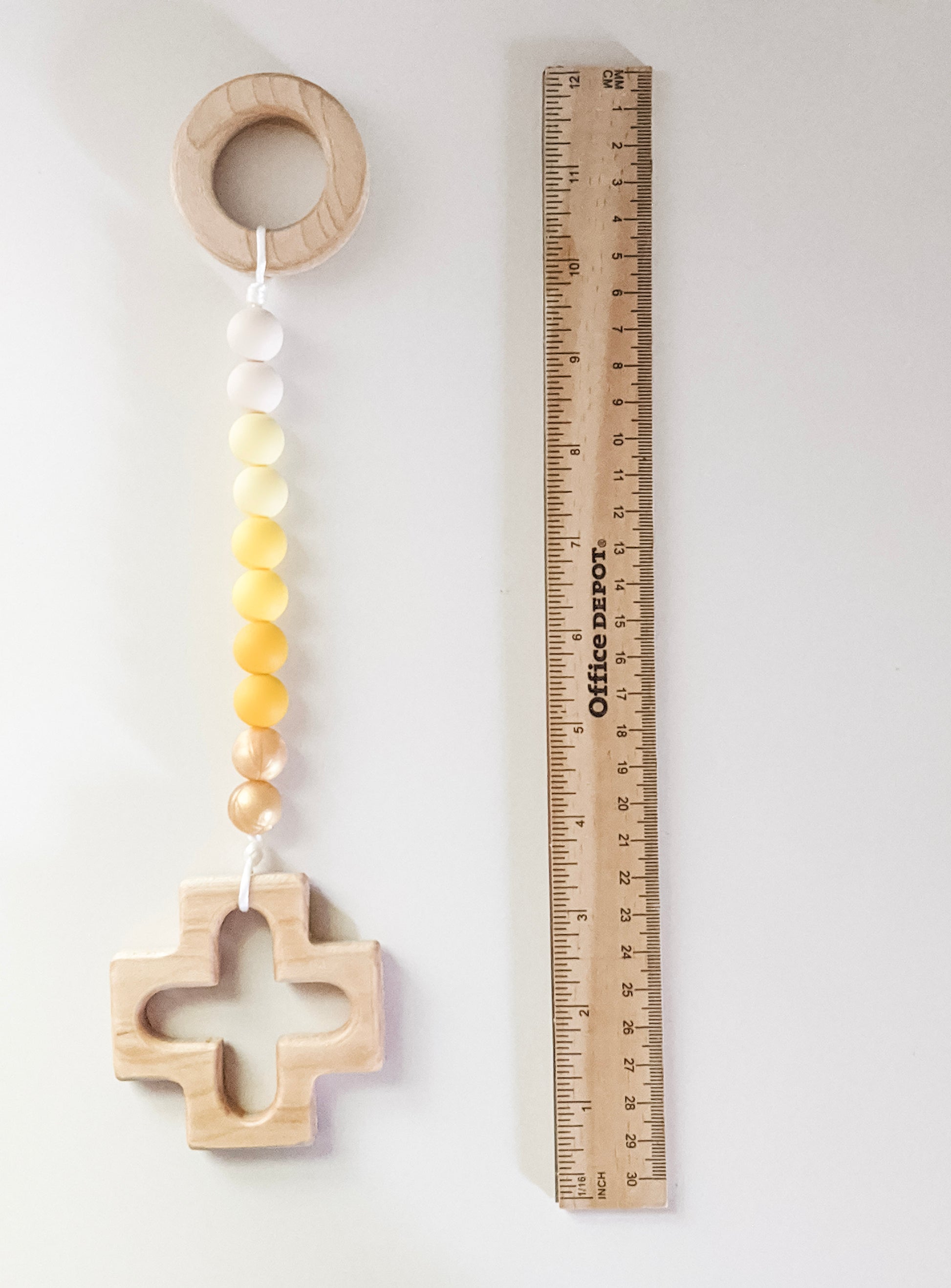 Yellow ombre rosary strand next to ruler showing measurement