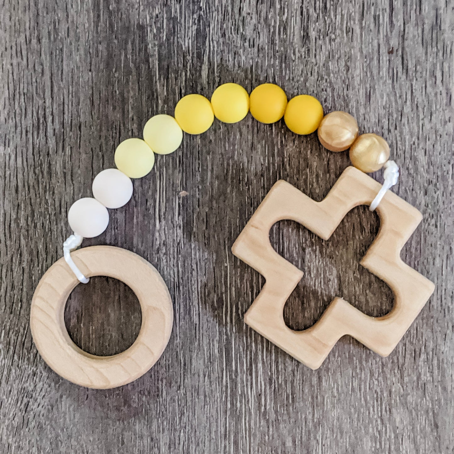 Yellow ombre silicone bead teething strand with wooden cross and ring at each end